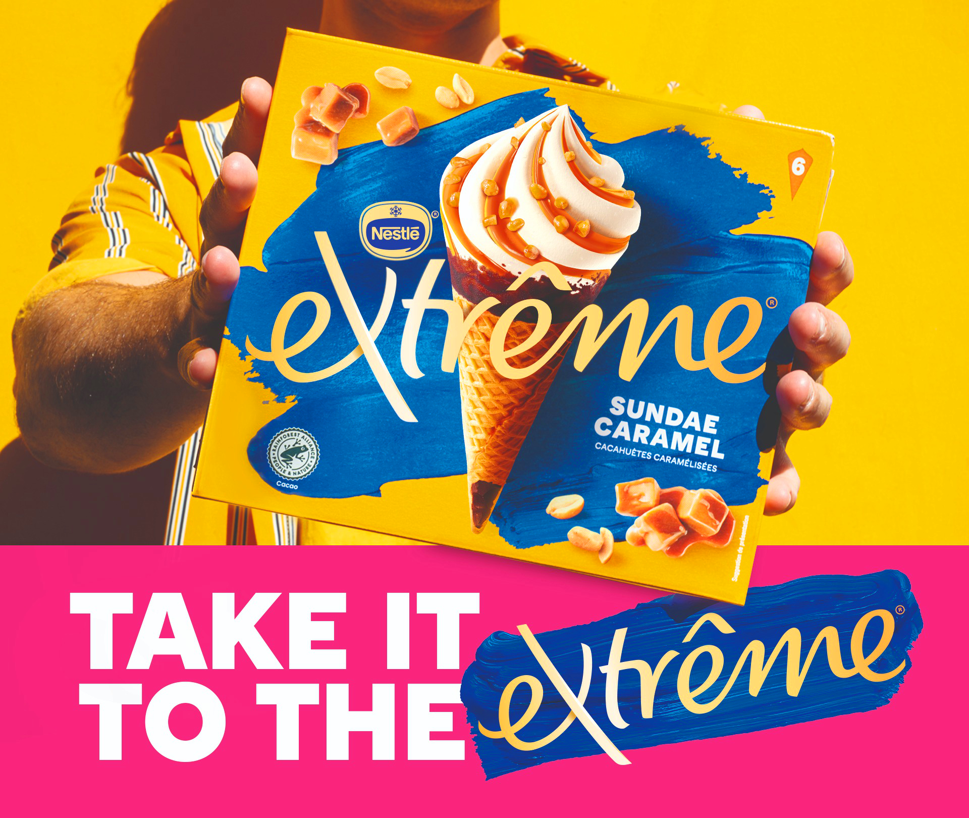 Man holding up Extreme box on yellow background